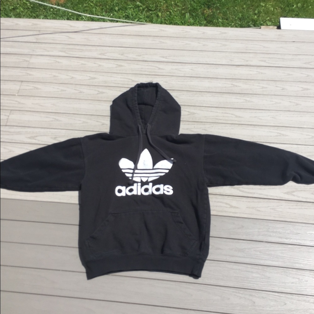 Slightly faded, black adidas hoodie.